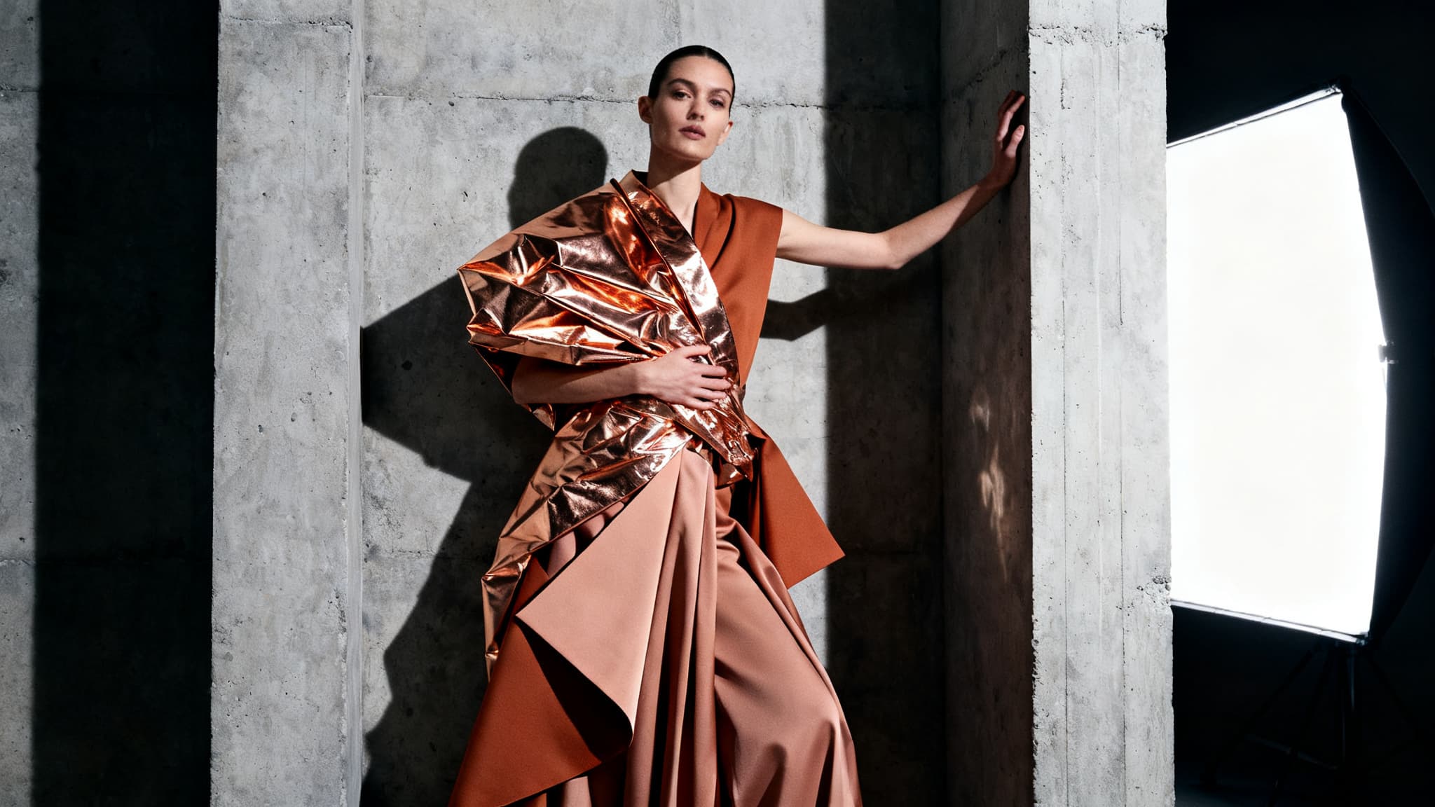 High-fashion editorial of a model in avant-garde copper-foil and silk couture.